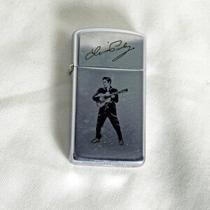 Vintage Elvis playing the guitar with signature Chrome Zippo 1987